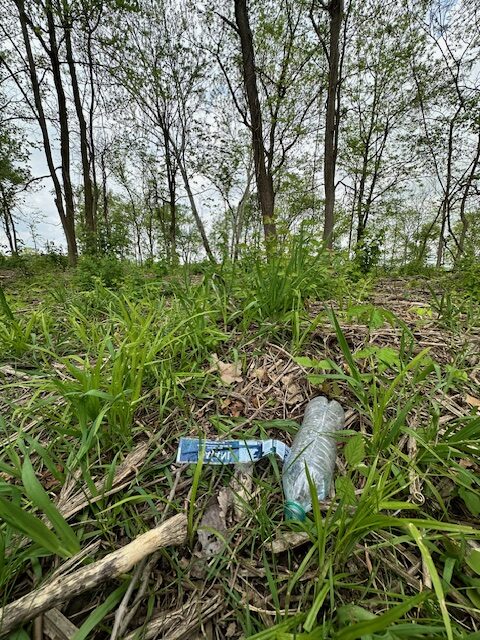 plastic bottle left on trail showing why Leave No Trace is important.