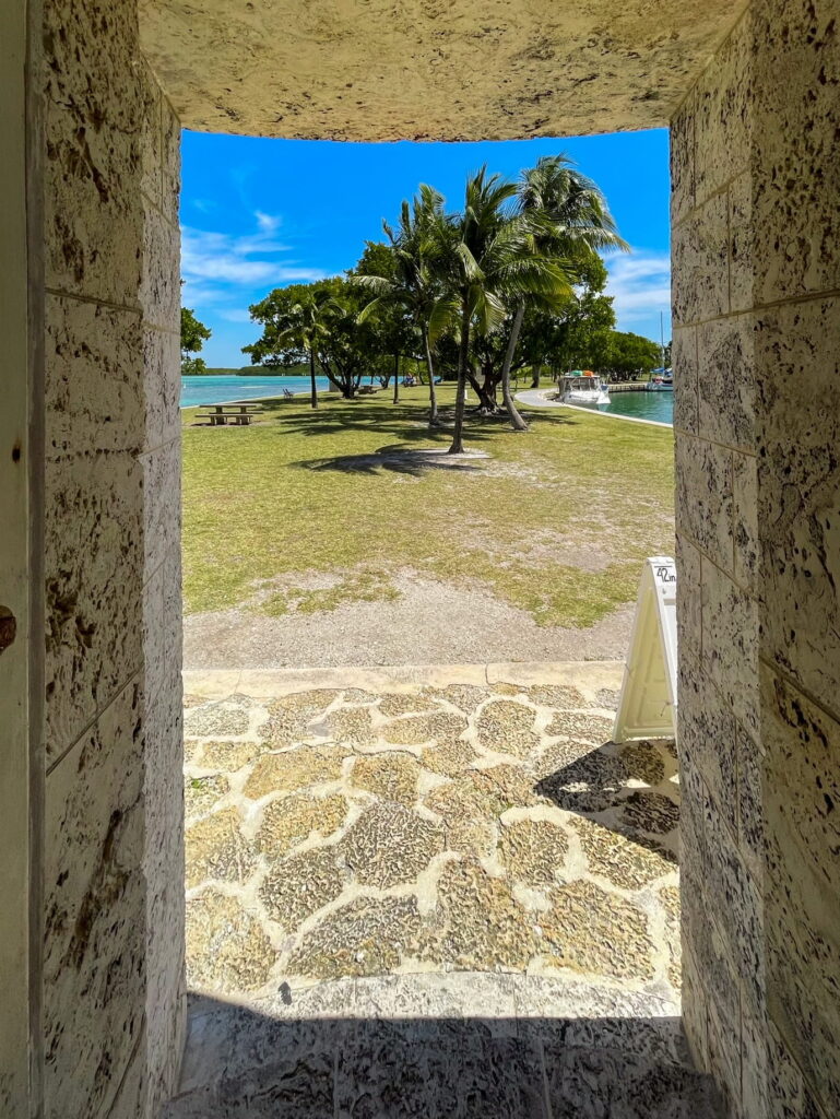 A hiker looks out of the Boca Chita Lighthouse at Biscayne National Park. Explore the lighthouse on your Biscayne National Park tour.