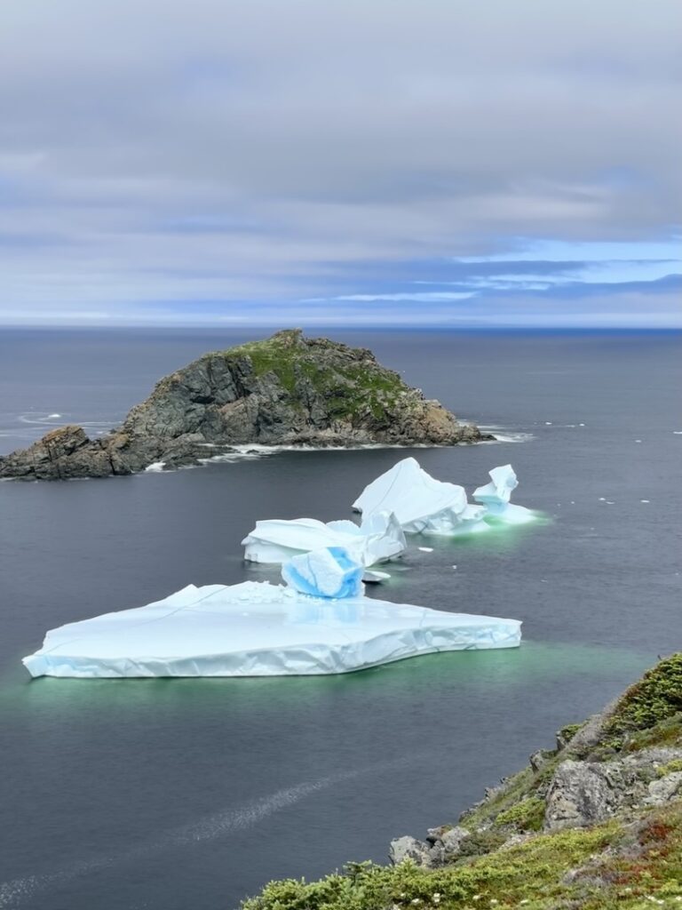 Icebergs floating at sea off the coast of Twillingate, Newfoundland. The Best time to visit Newfoundland to see icebergs is Late May and early June.