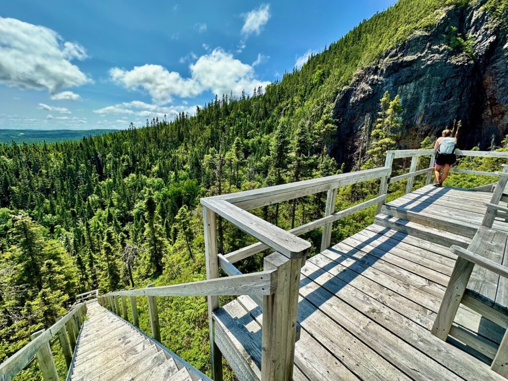 A hiker taking a rest on an overlook point as they climb 2,200 stairs on the Alexander Murray Hiking Trail.