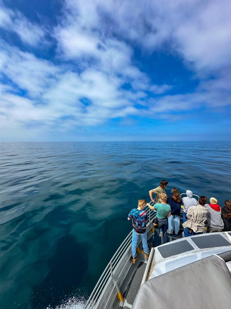 Fellow travelers stand at the front of the Island Packers Boat on a Channel Islands day trip.
