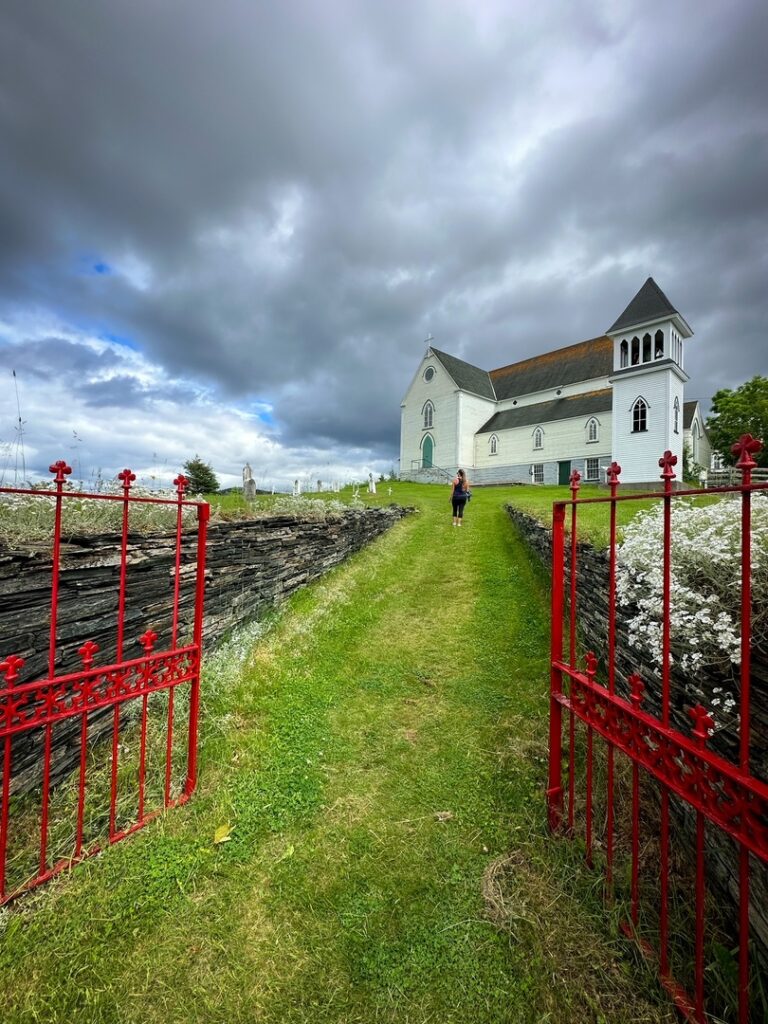 Saint George Church of England through its red gates, Brigus, Newfoundland.