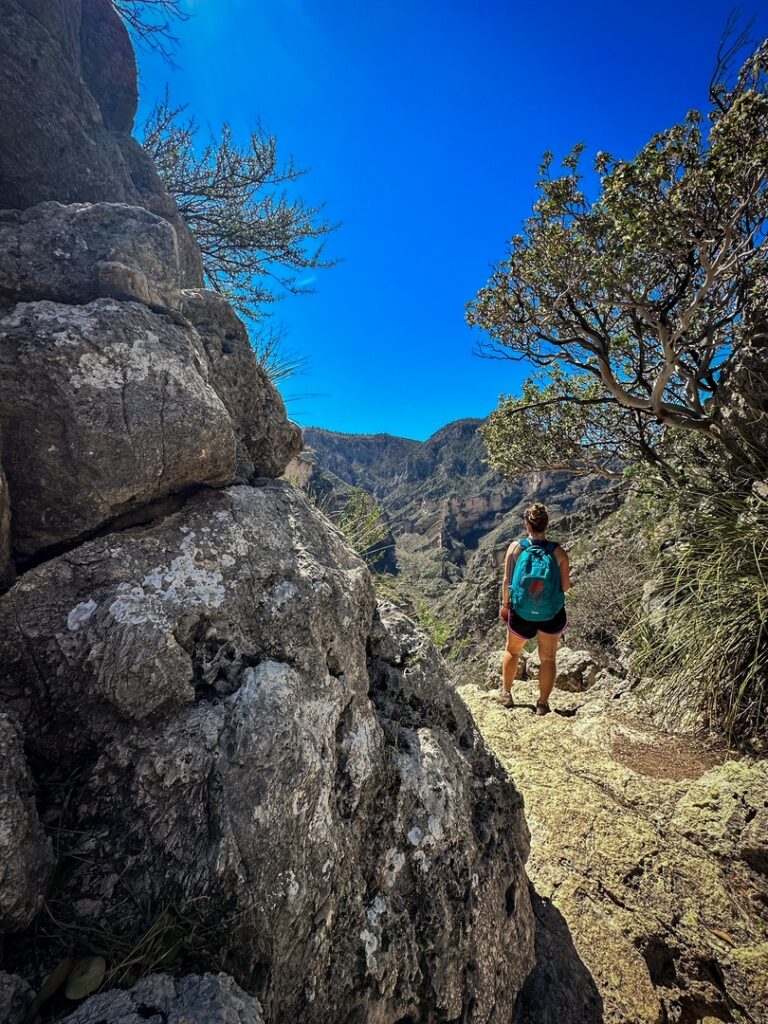 A hiker standing at The Notch along the trail, one of the best hikes in Guadalupe Mountains National Park