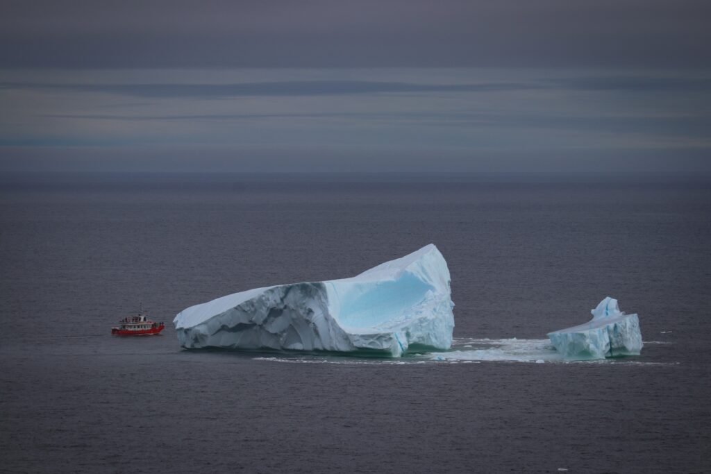 A tour boat gets up close and personal with an iceberg in Twillingate.