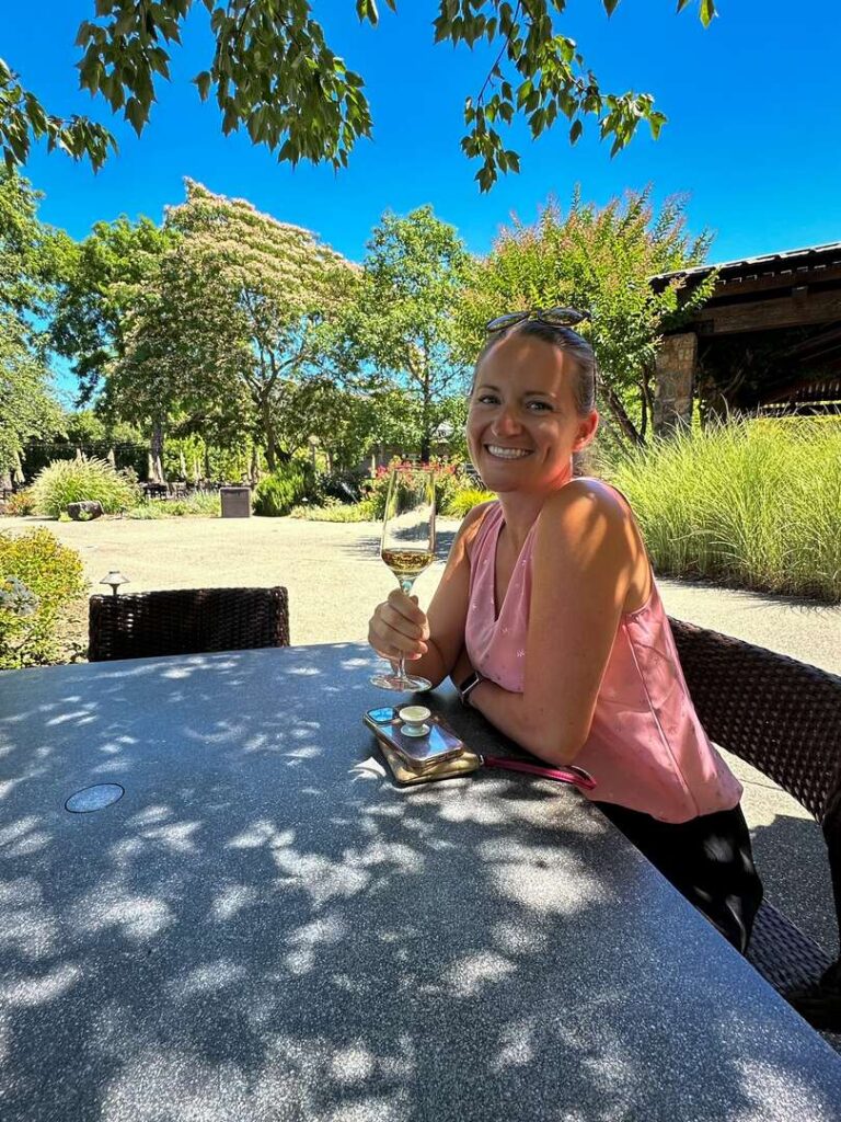 A visitor tries a sip of wine on the patio at Kunde Family Winery during a day trip to Sonoma.