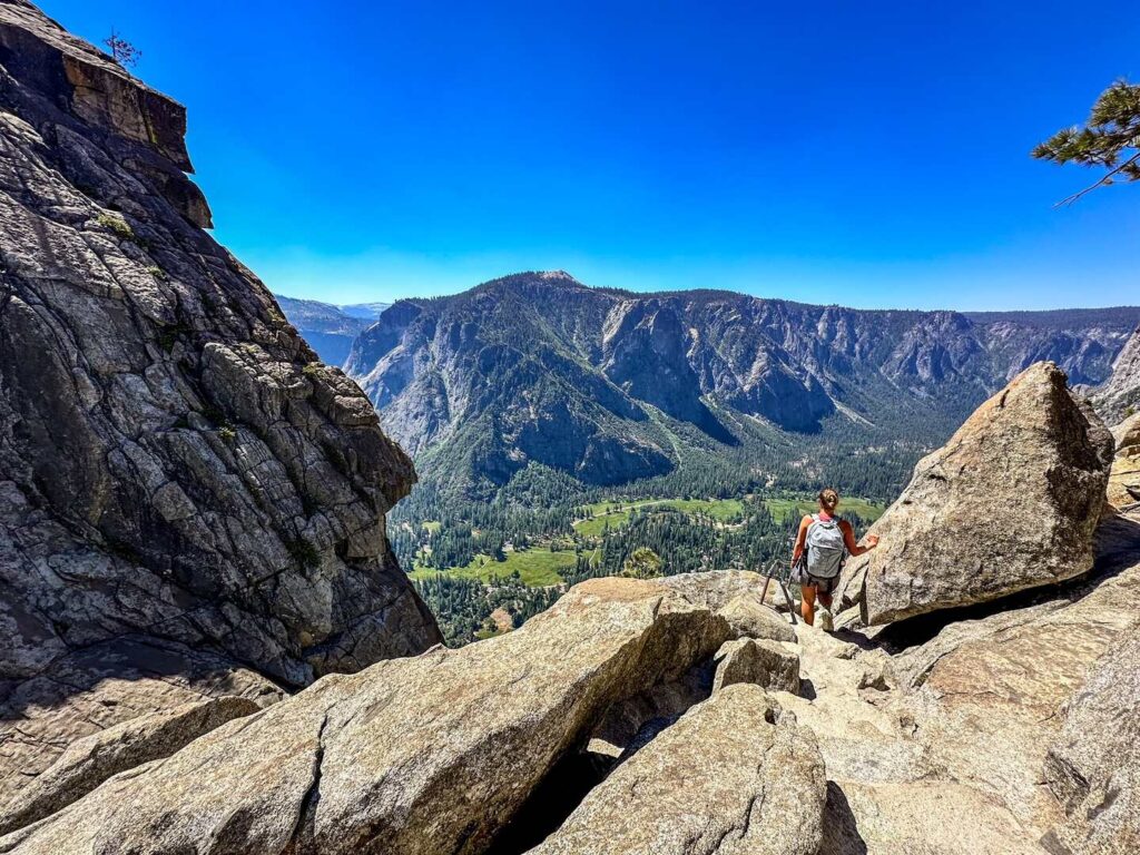 A hiker gets ready to descend to the bring of Upper Yosemite Falls.
