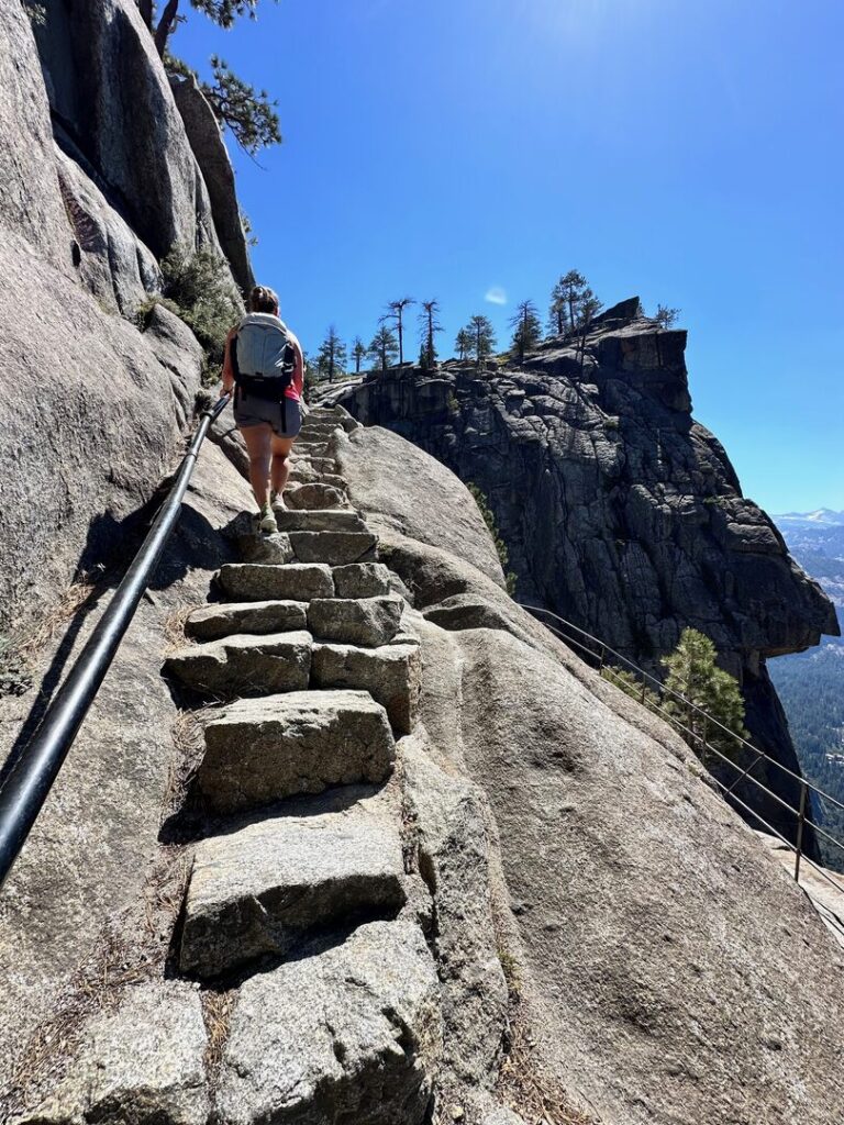 A hiker climbing up the sketchy stairs at Yosemite.