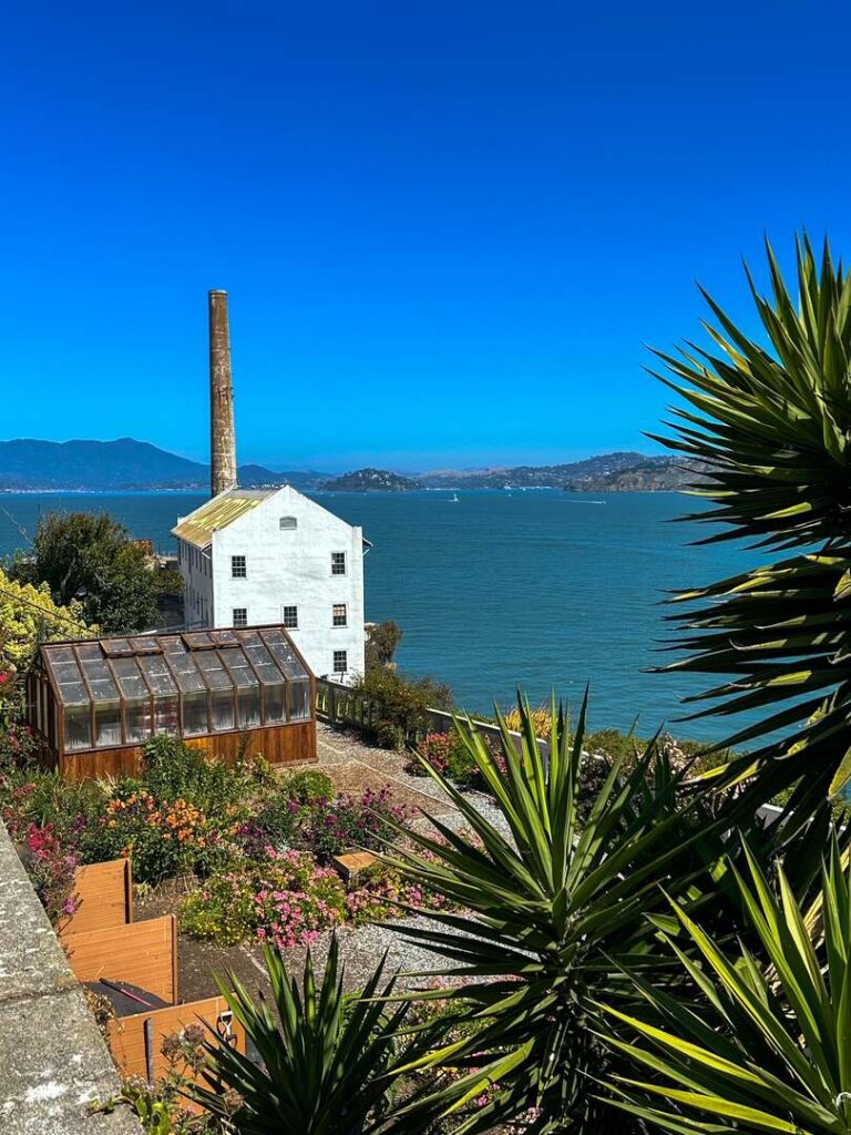 Is Alcatraz Worth visiting? This picture of the powerhouse and beautiful gardens overlooking the ocean is one reason to visit.