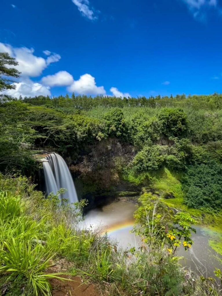 The waterfall as seen from the Wailua Falls overlook in Kauai complete with a rainbow.