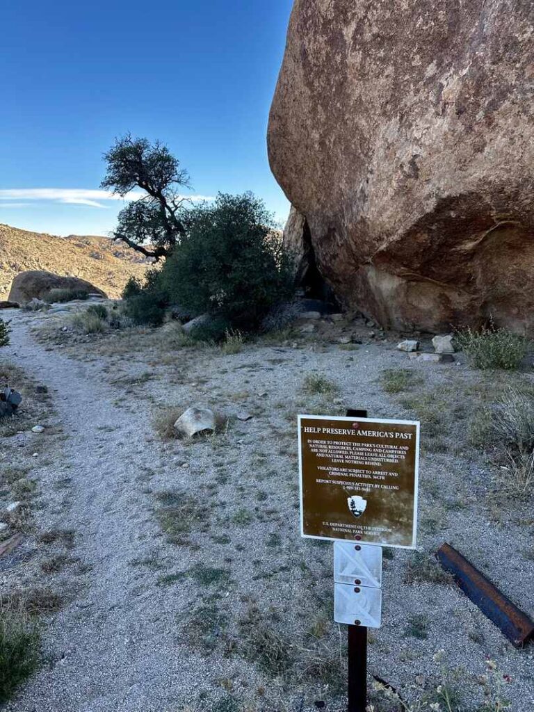 A sign at the end of the Desert Queen Mine and Eagle Cliff Boulder House asking those who visit to help preserve America's past by leaving all artifacts in place.